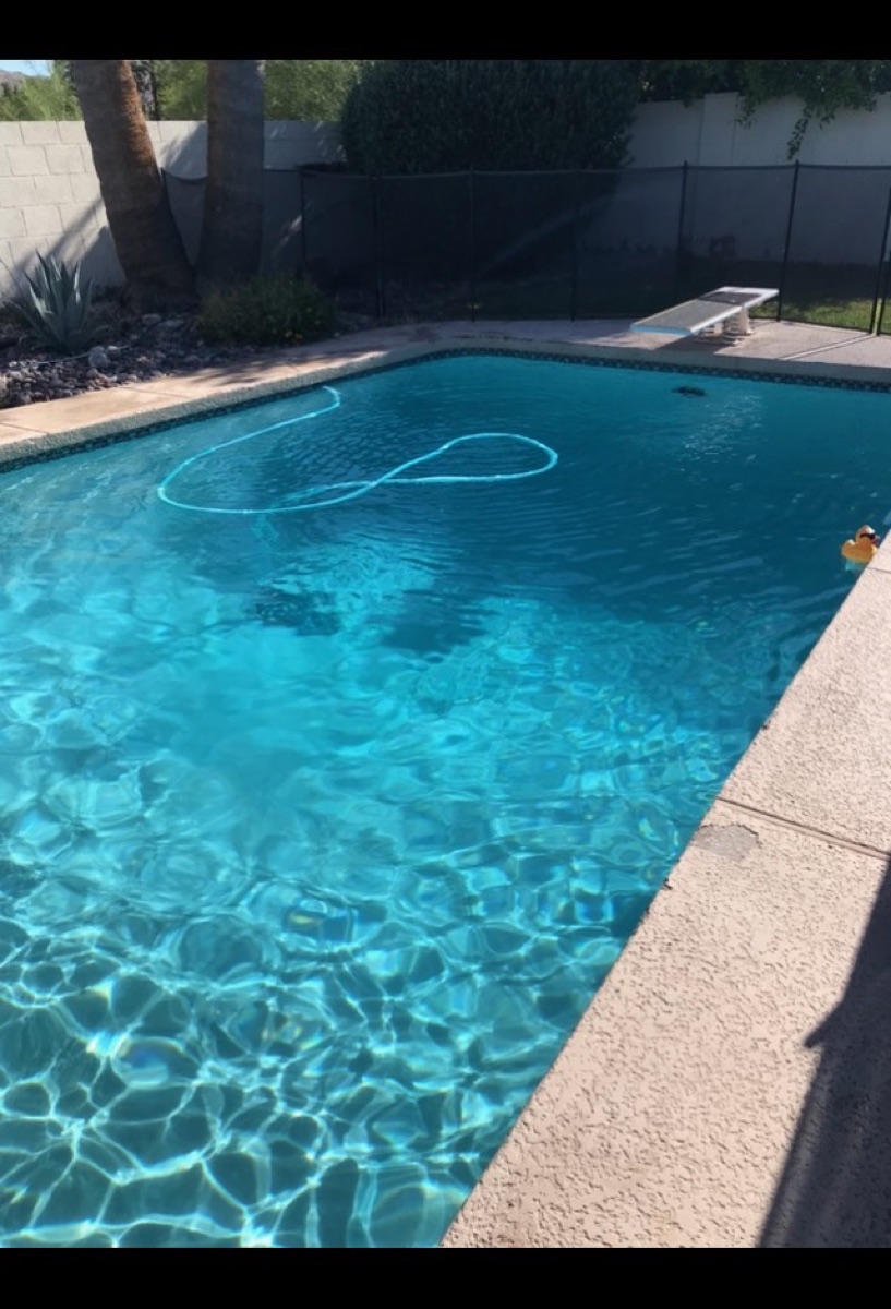 Sparkling turquoise pool water after weekly cleaning in Phoenix